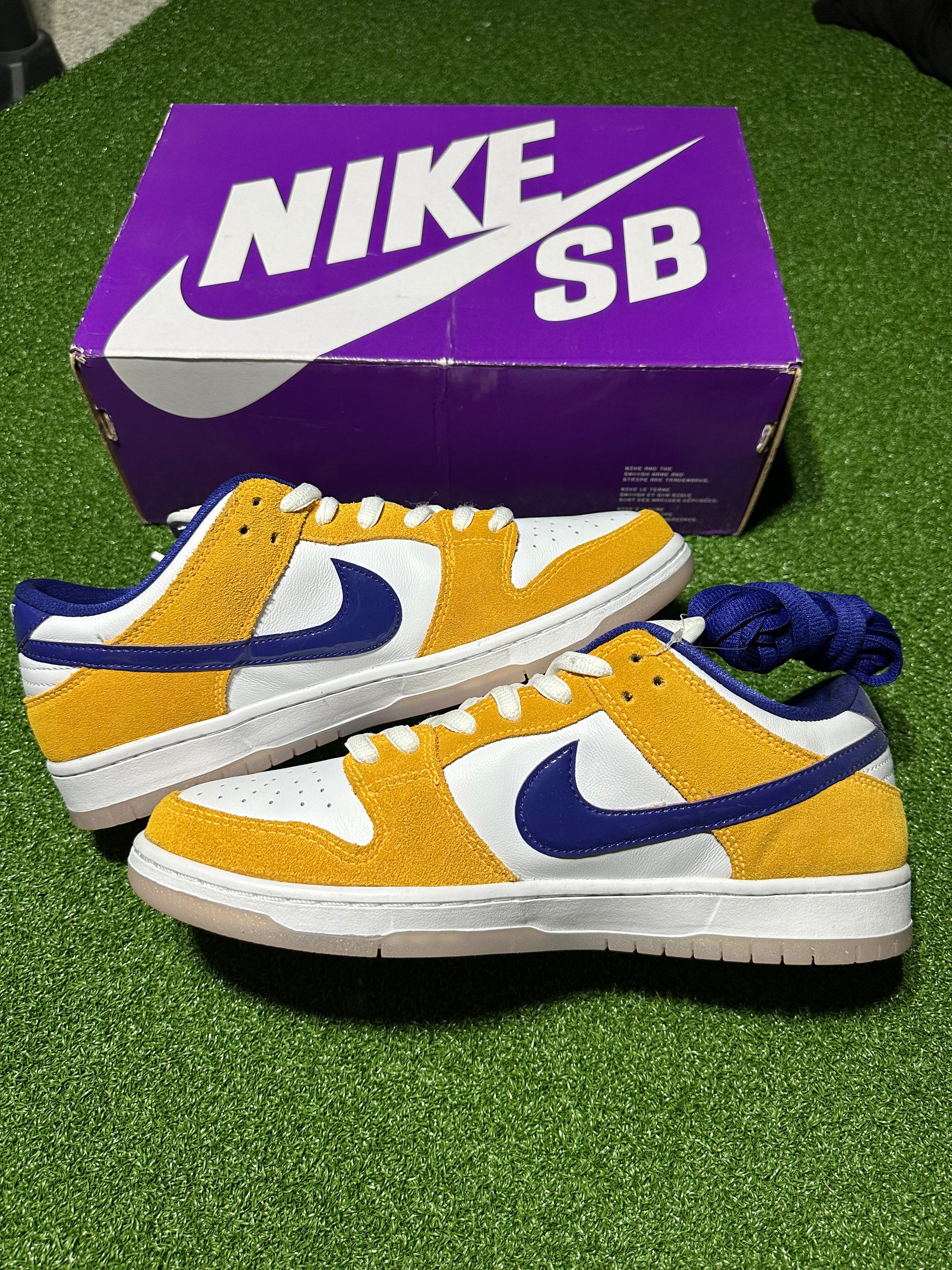Yellow and blue Nike SB sneakers with a purple box in the background