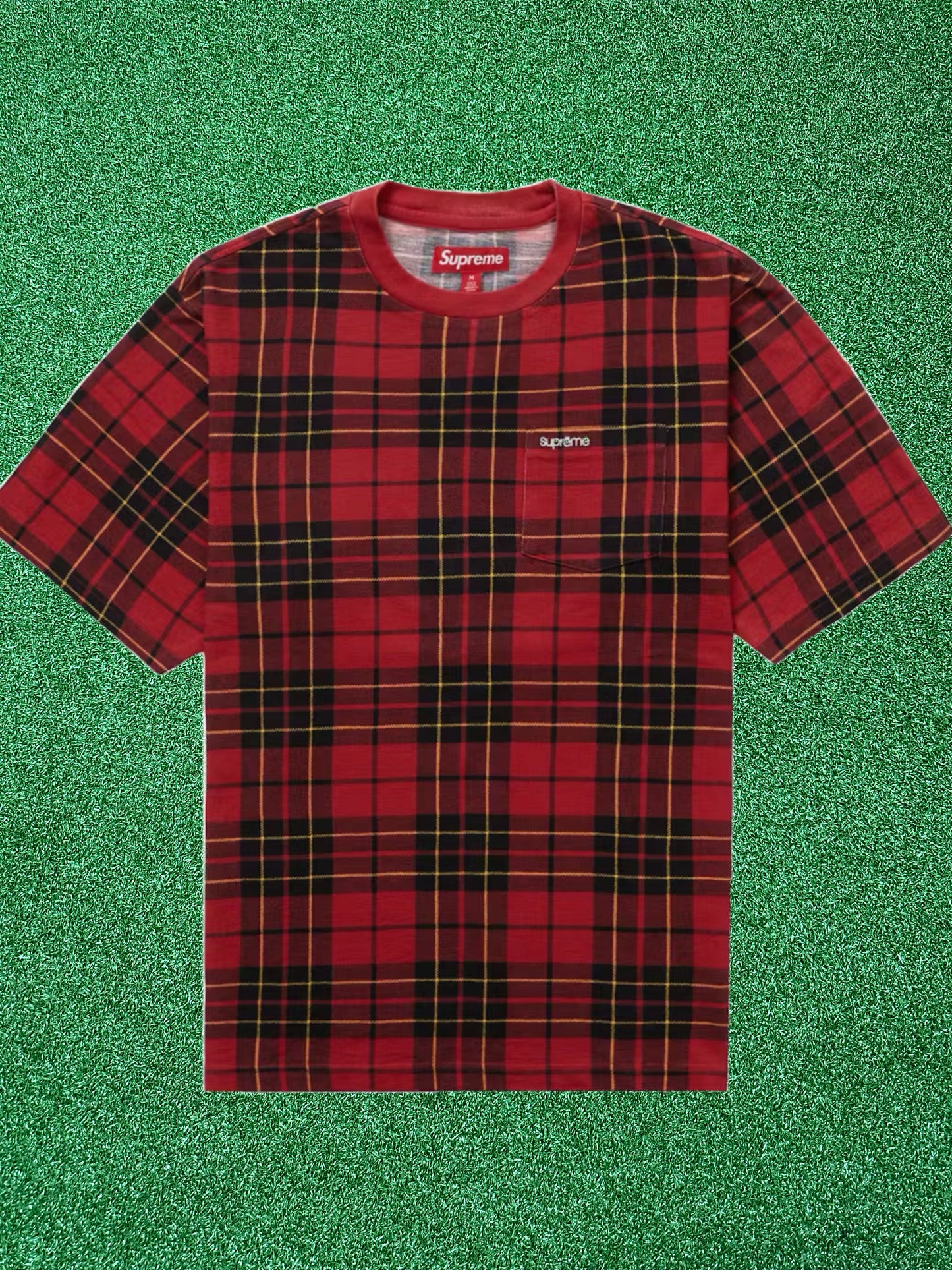 Red plaid t-shirt with Supreme logo on a green textured background